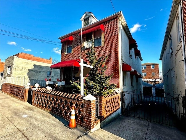 view of side of property with fence and brick siding