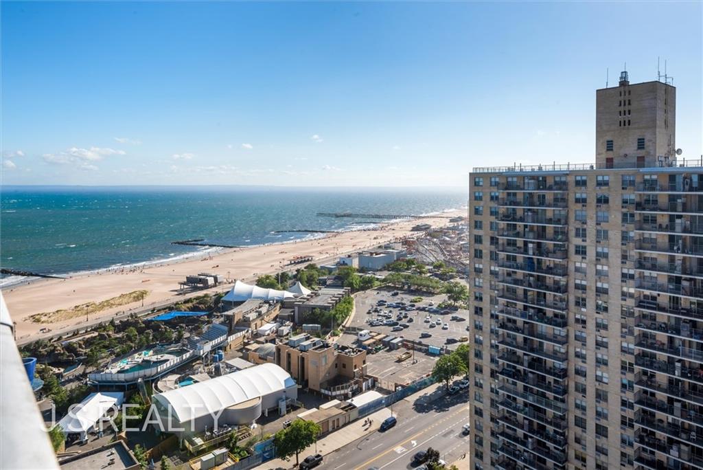 drone / aerial view with a water view and a view of the beach