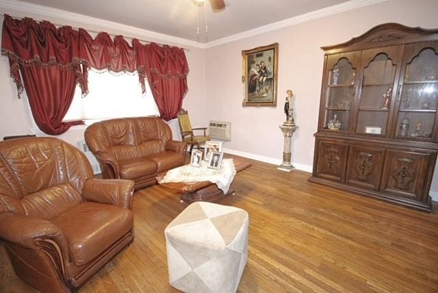 living room with wood-type flooring, crown molding, and ceiling fan