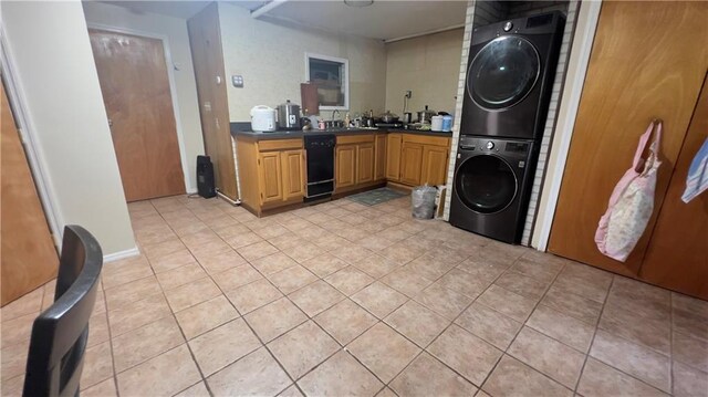 kitchen with sink, stacked washer and clothes dryer, black dishwasher, and light tile patterned flooring