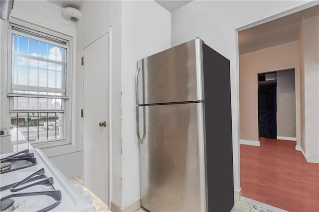 kitchen featuring stainless steel fridge and light wood-type flooring