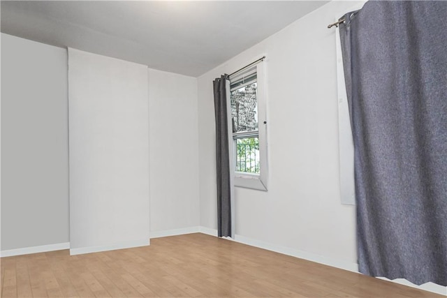 empty room with wood-type flooring