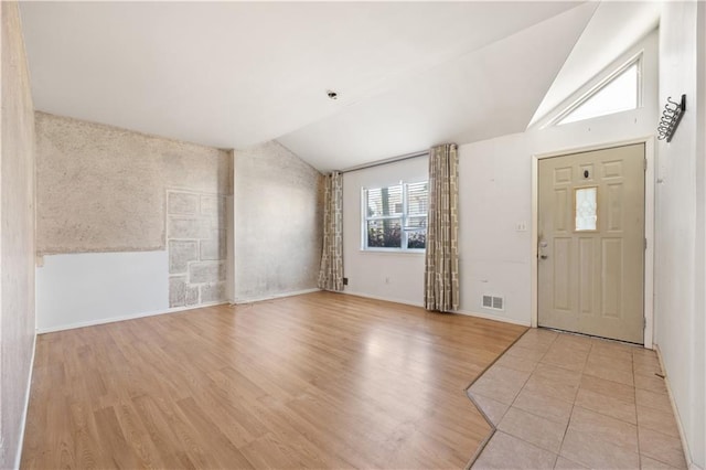 foyer featuring vaulted ceiling and light wood-type flooring