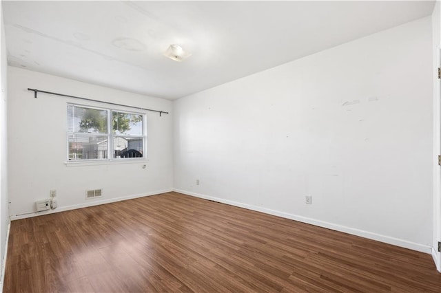 spare room featuring dark hardwood / wood-style floors