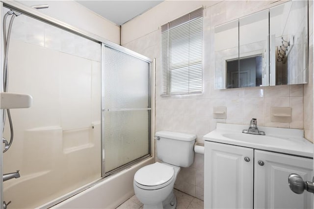 full bathroom with vanity, enclosed tub / shower combo, tile walls, and toilet