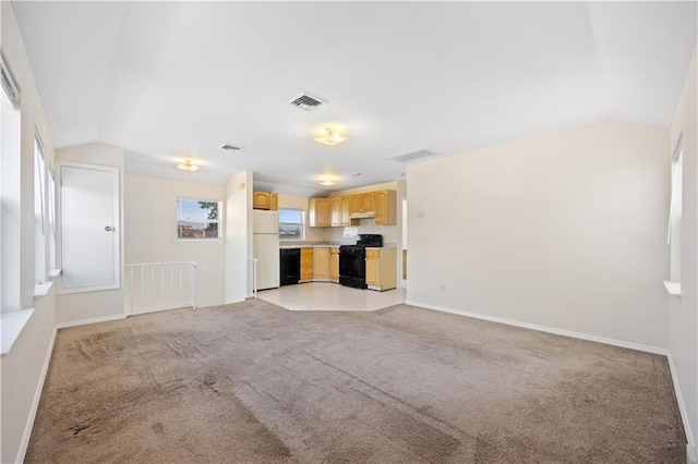 unfurnished living room featuring light colored carpet and vaulted ceiling