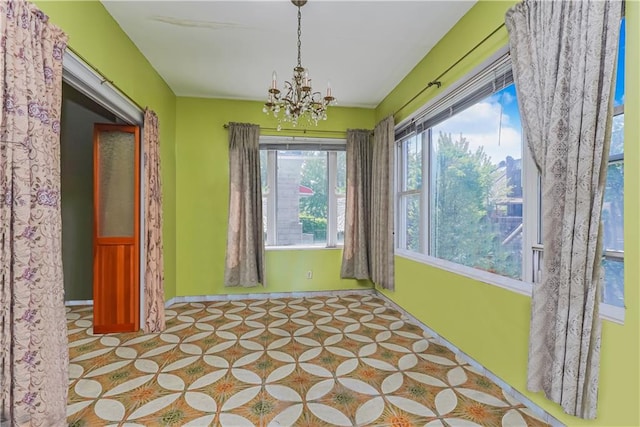 unfurnished sunroom with a chandelier