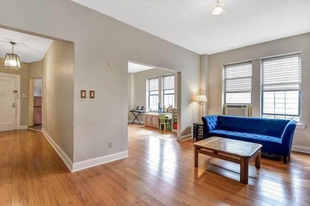 living room with cooling unit and hardwood / wood-style flooring