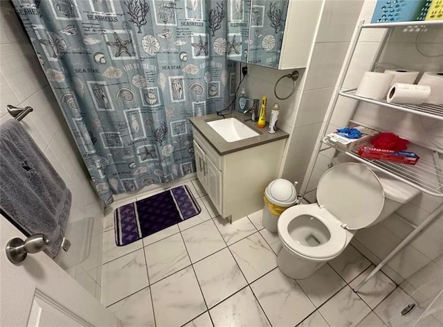 bathroom featuring vanity, tile walls, curtained shower, and toilet