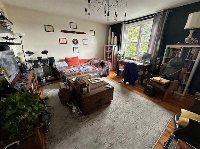 living area featuring an inviting chandelier and hardwood / wood-style floors