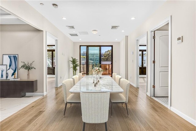 dining space with light wood-type flooring