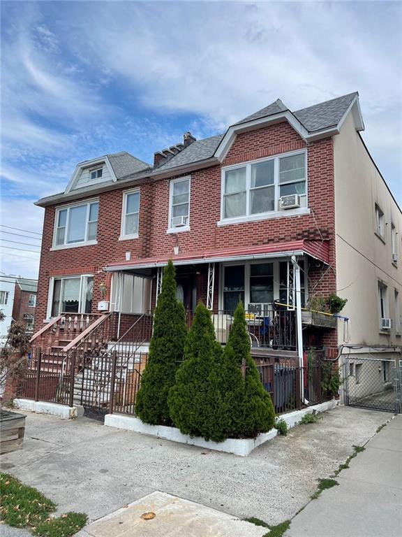 8689 15th Ave, Brooklyn, NY 11228 - view of property featuring brick siding, fence, and cooling unit