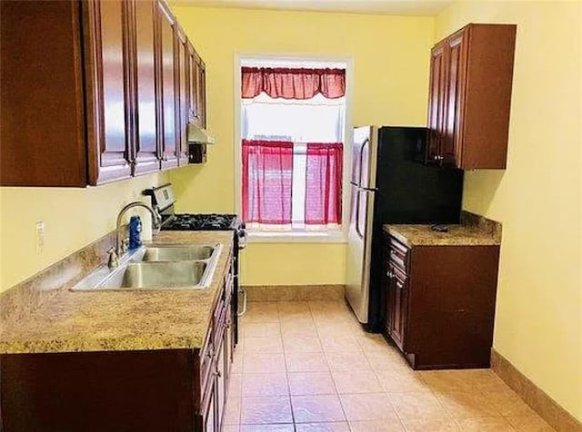 kitchen featuring sink, light tile patterned floors, and stainless steel appliances