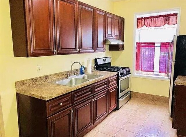 8689 15th Ave, Brooklyn, NY 11228 - kitchen featuring a sink, gas stove, light countertops, baseboards, and under cabinet range hood
