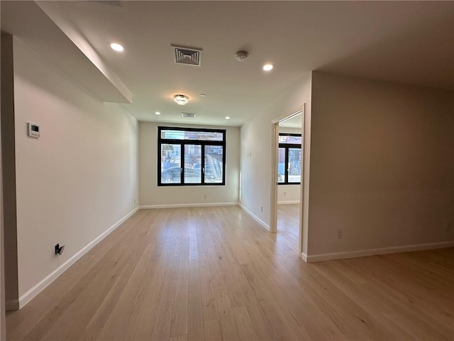 207 Bay 35th St Unit 1A, Brooklyn, NY 11214 - empty room with light wood-type flooring, recessed lighting, and a smoke detector