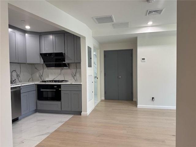 207 Bay 35th St Unit 1A, Brooklyn, NY 11214 - kitchen with stainless steel dishwasher, black oven, gray cabinetry, exhaust hood, and recessed lighting