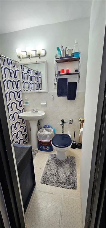 full bath with tile patterned flooring, tile walls, and a shower with shower curtain