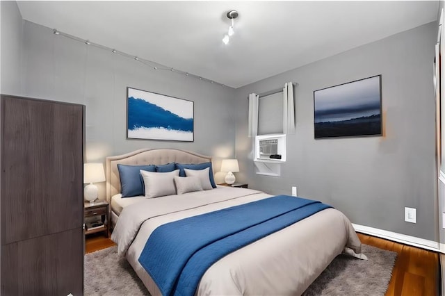 bedroom featuring baseboards and wood finished floors