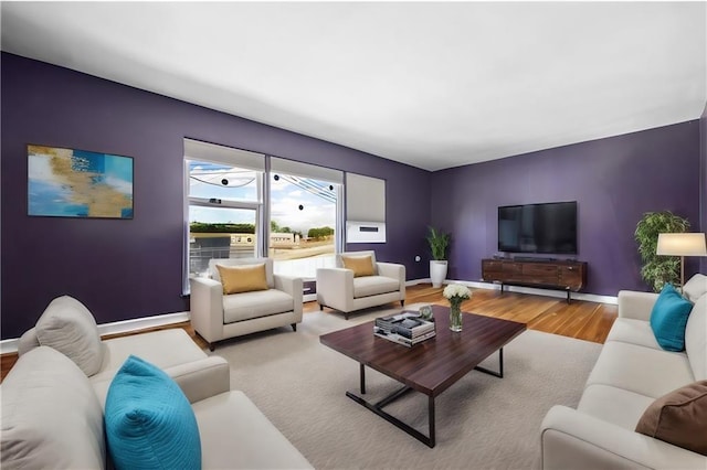 living room with baseboards and wood finished floors