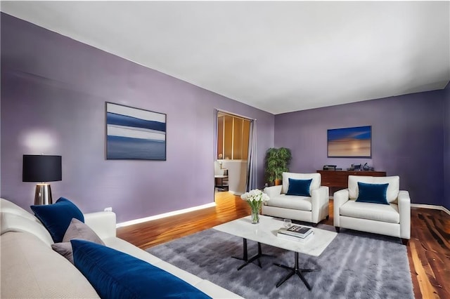 living room featuring baseboards and wood finished floors