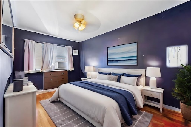 bedroom featuring baseboards, a ceiling fan, and light wood-type flooring
