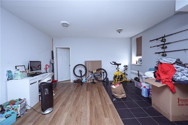 exercise room with wood finished floors