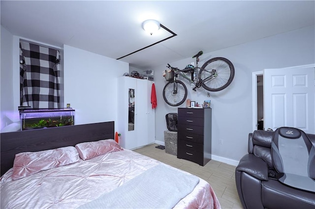 bedroom with baseboards and light tile patterned floors