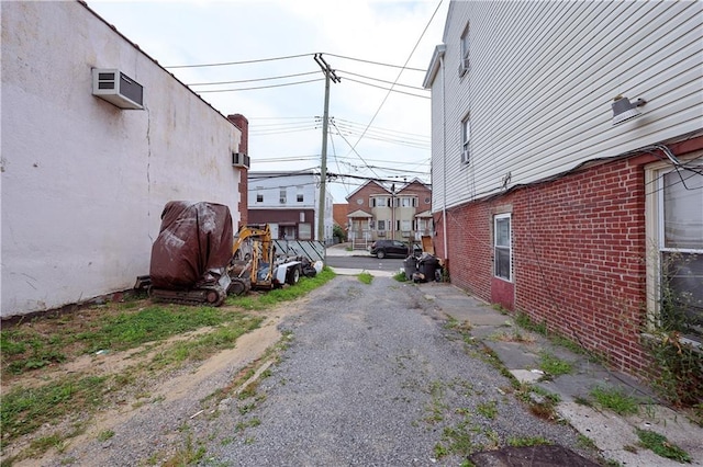 view of dirt / gravel road featuring a residential view