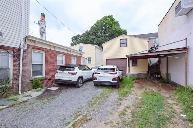 view of home's exterior featuring an attached garage and a chimney