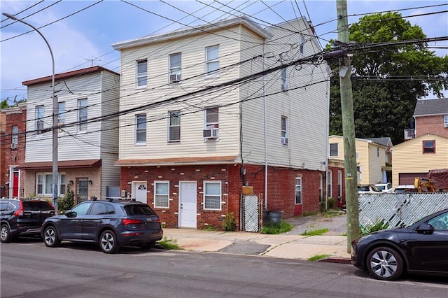 view of front of home featuring brick siding and cooling unit