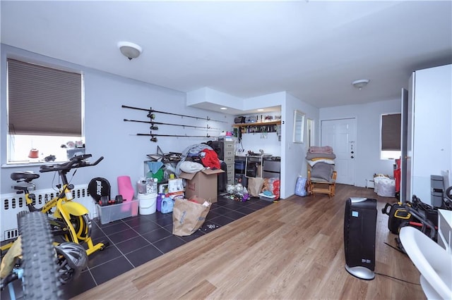 12011 14th Rd, Queens, NY 11356 - interior space with wood finished floors and a baseboard heating unit