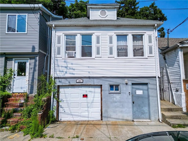 view of front of house featuring cooling unit and a garage