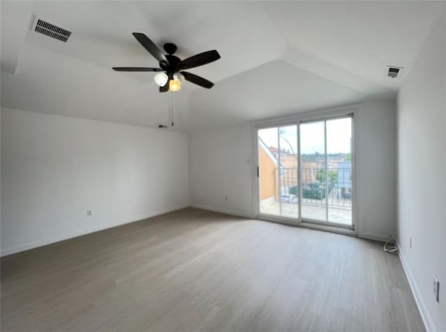 spare room featuring lofted ceiling, ceiling fan, and hardwood / wood-style flooring