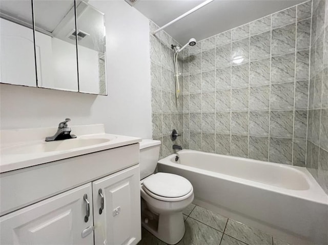 full bathroom featuring tile patterned floors, tiled shower / bath combo, vanity, and toilet