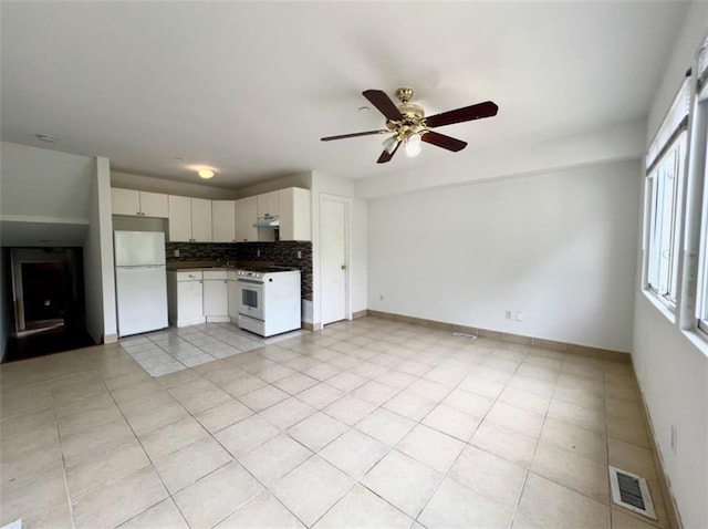 kitchen with tasteful backsplash, white cabinets, white appliances, light tile patterned floors, and ceiling fan