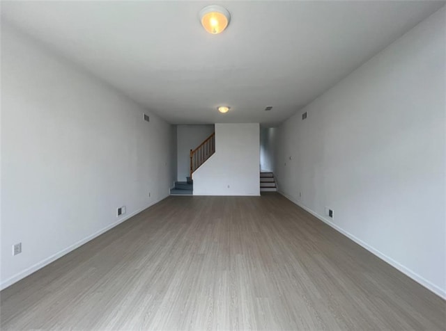 unfurnished living room featuring wood-type flooring