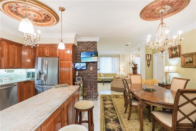 kitchen featuring an inviting chandelier, stainless steel appliances, tile patterned floors, decorative light fixtures, and light stone countertops