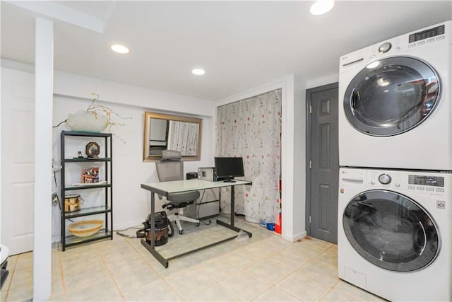 washroom with light tile patterned floors and stacked washer and dryer