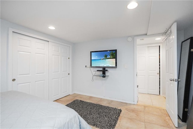 bedroom with a closet and light tile patterned floors