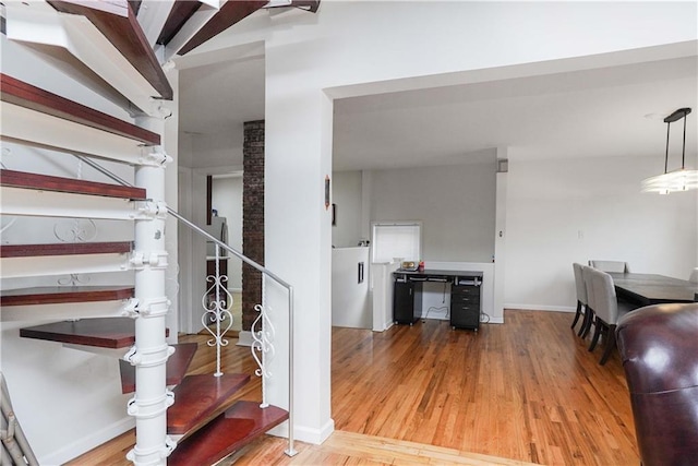 stairway with hardwood / wood-style flooring