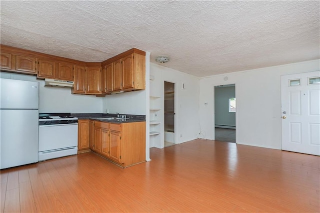 kitchen with a baseboard heating unit, light hardwood / wood-style floors, a textured ceiling, sink, and white appliances