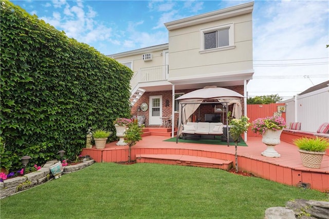 back of property featuring outdoor lounge area, a gazebo, and a yard