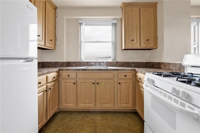 kitchen featuring light brown cabinetry, sink, and white appliances