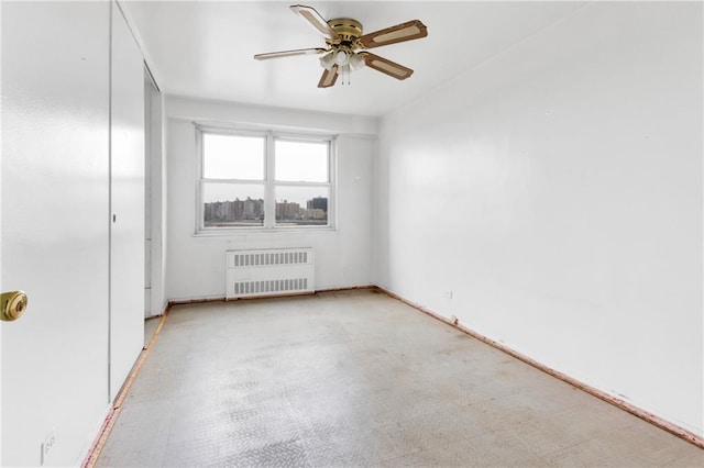 empty room with ceiling fan and radiator heating unit