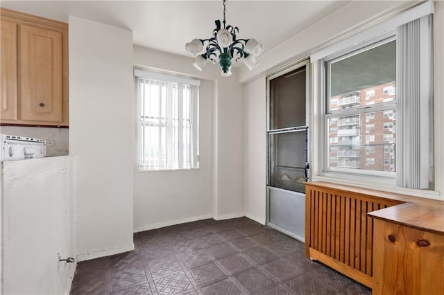 interior space featuring radiator and an inviting chandelier