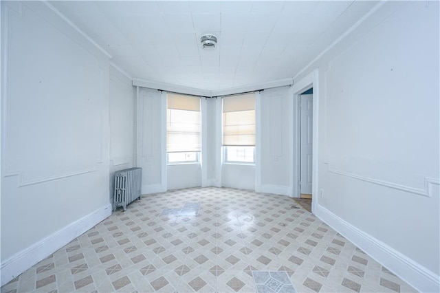 unfurnished living room featuring tile patterned flooring and radiator