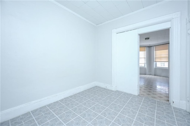 tiled spare room with ornamental molding