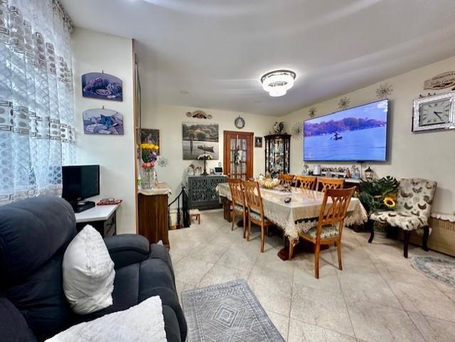 dining area with light tile patterned floors