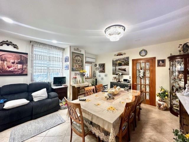 tiled dining area with a wall mounted air conditioner and a notable chandelier