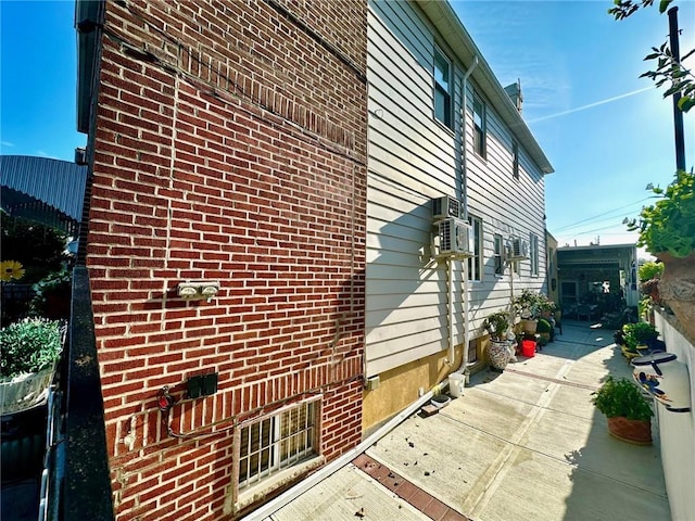 view of home's exterior with a patio and cooling unit